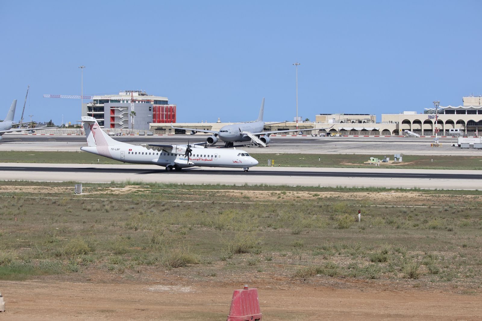 A small passenger aircraft on a runway beside the Toronto waterfront