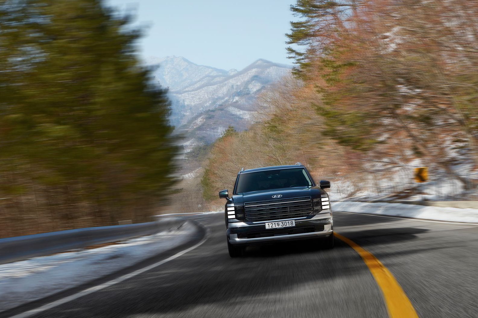 A black SUV at a snowy resort entrance, the usual vehicle for a Blue Mountain ski day