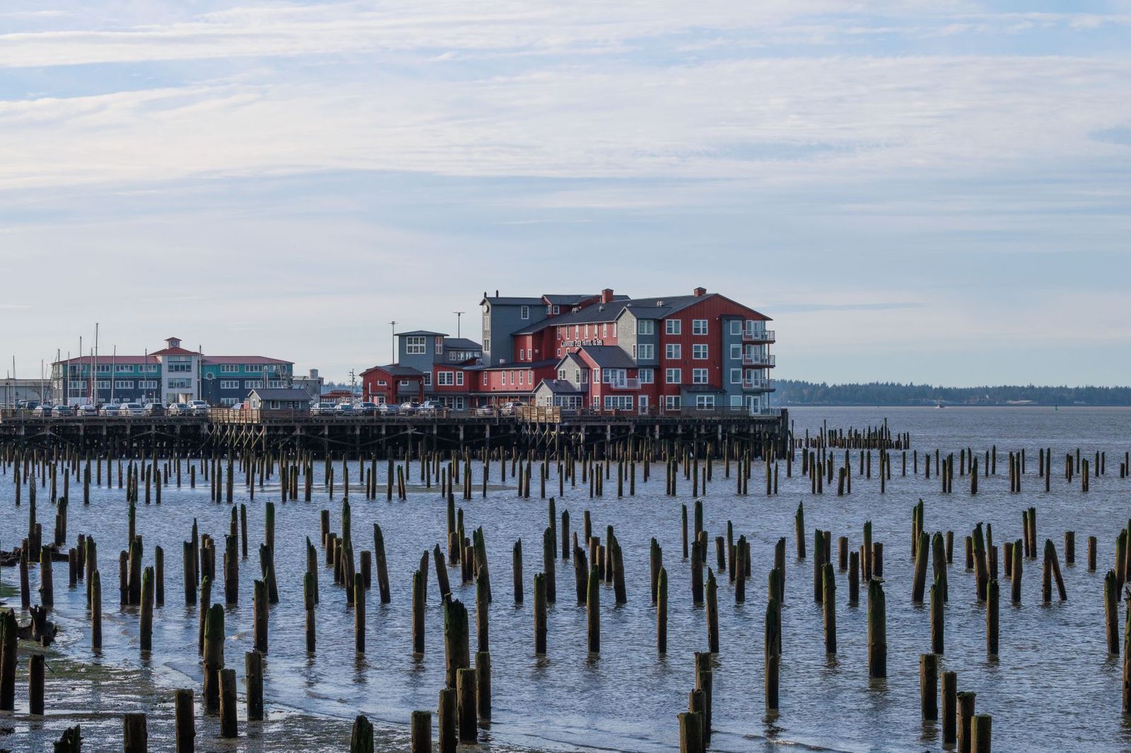 A bay shoreline with historic wooden buildings, the sort of setting around a heritage harbour