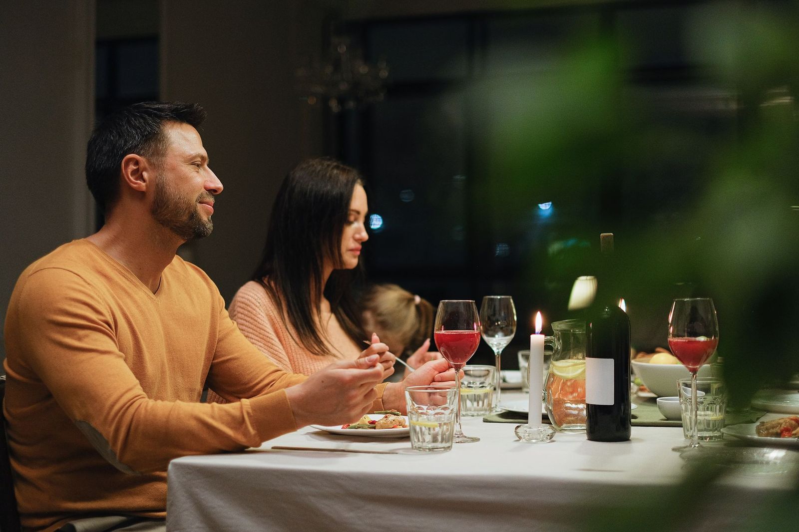 A couple sharing dinner at an evening restaurant table, the classic start to a chauffeured night out before a Barrie show