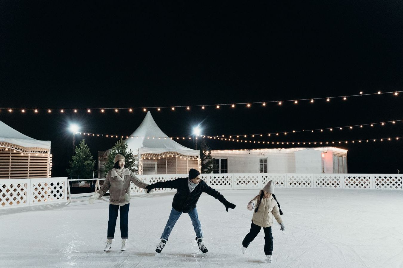 Outdoor skating rink lit at dusk, the kind of seasonal scene Friday Harbour programmes for March Break