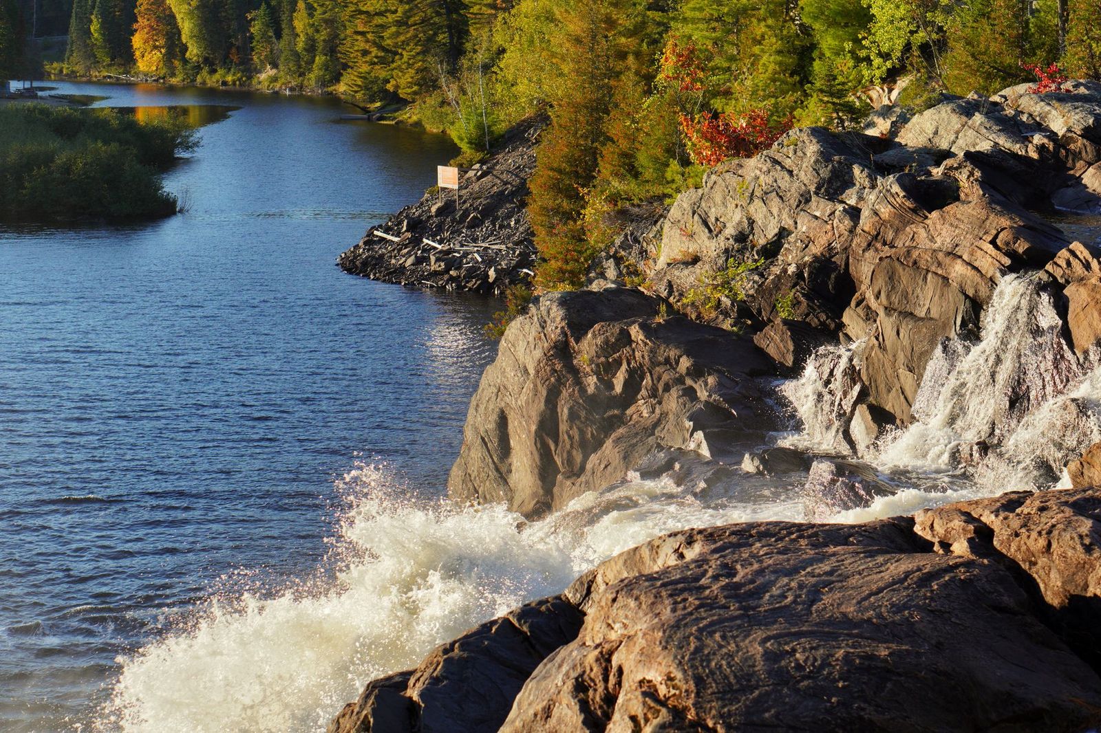 A small Muskoka town and river in autumn, the kind of stop an hourly chauffeur makes easy