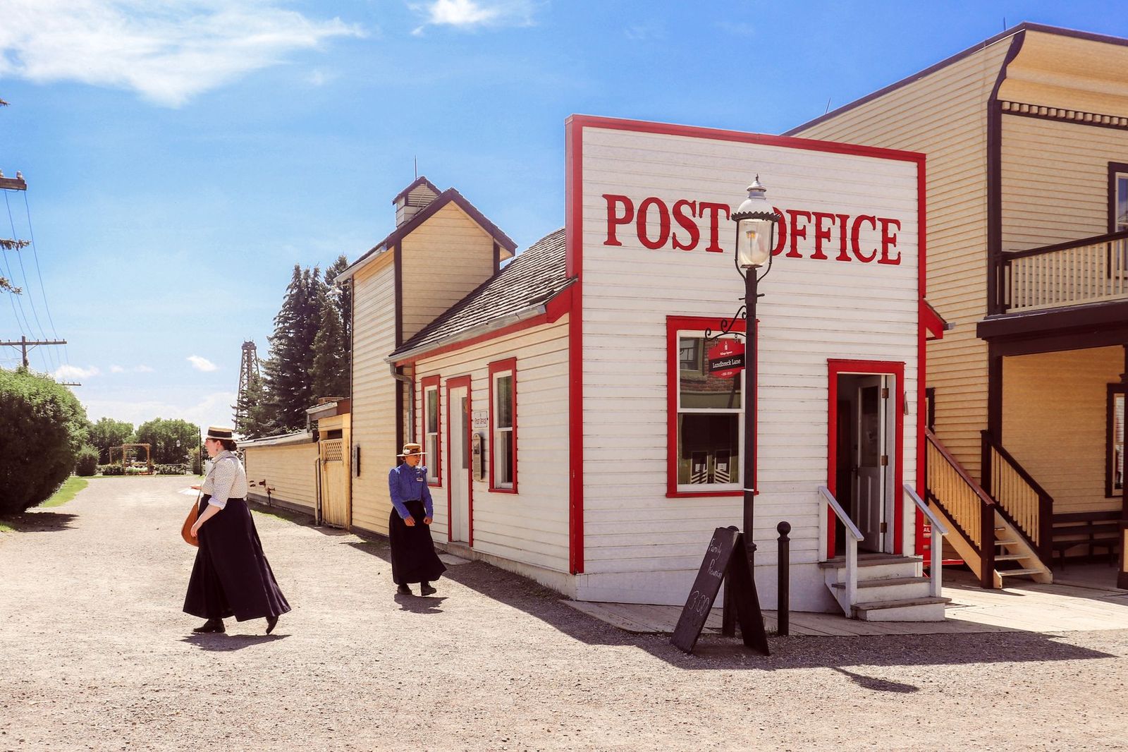 A costumed interpreter in a reconstructed historic village, the kind of living-history setting visitors walk through