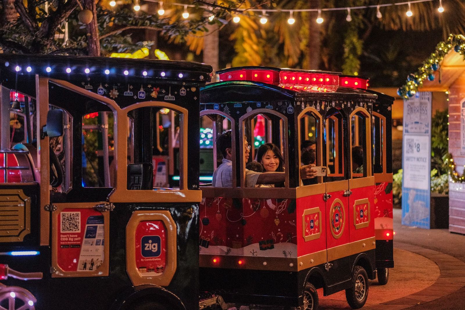 A family riding a miniature train, the kind of day a chauffeur takes the driving out of