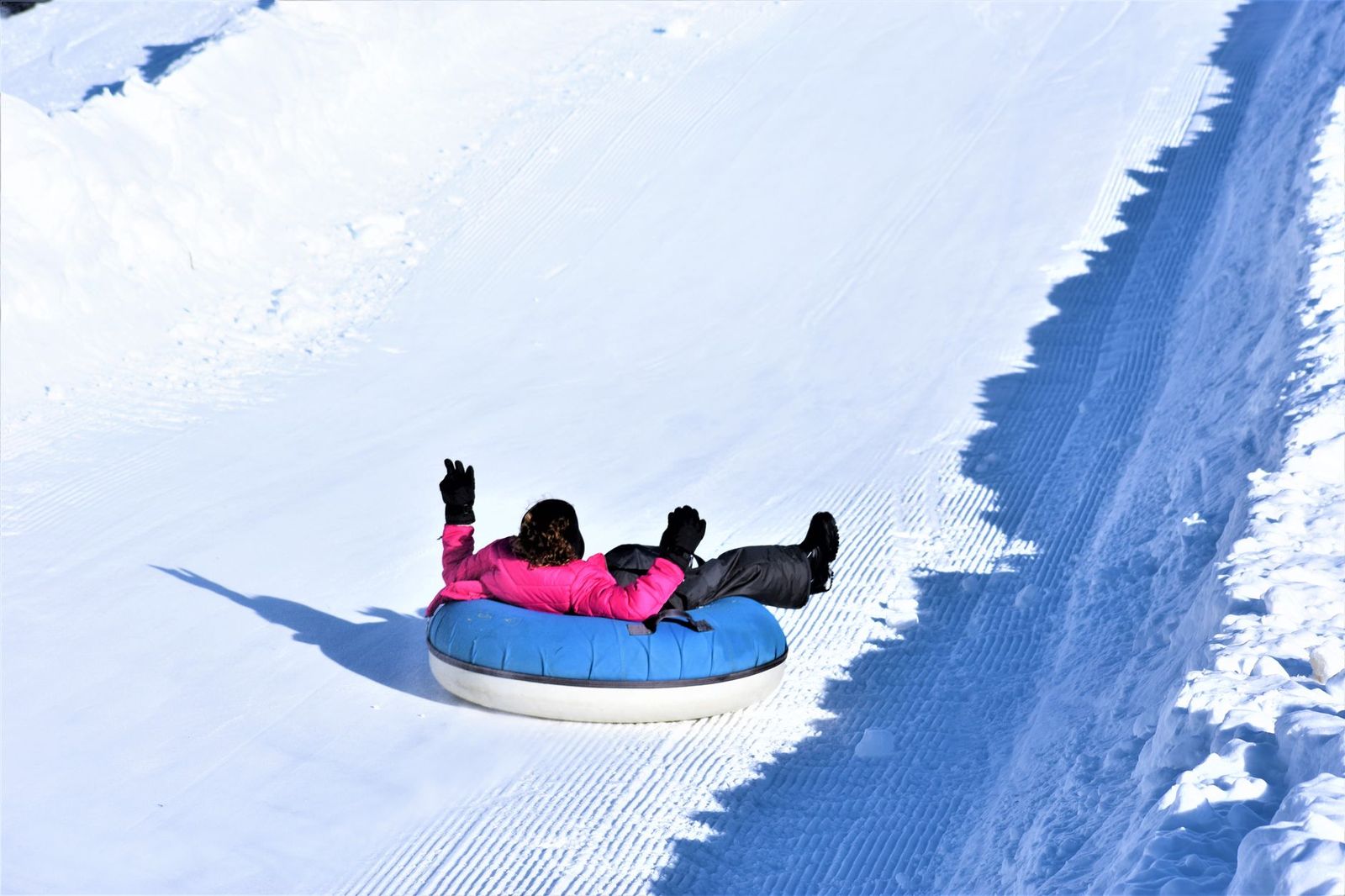 Children on a snow-tubing hill in winter, the activity that drives most family trips to Snow Valley