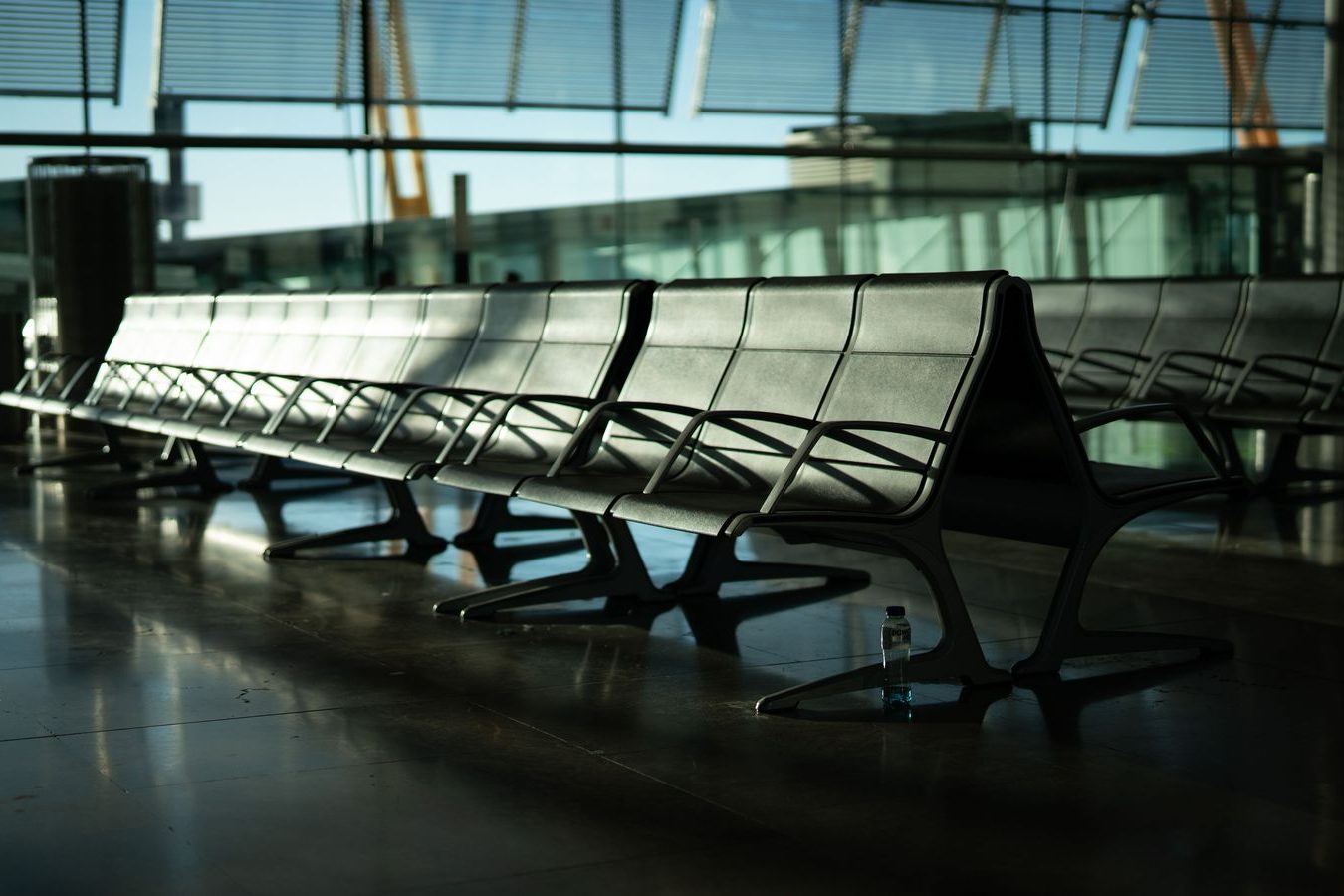 An airport departures sign glowing in the early morning