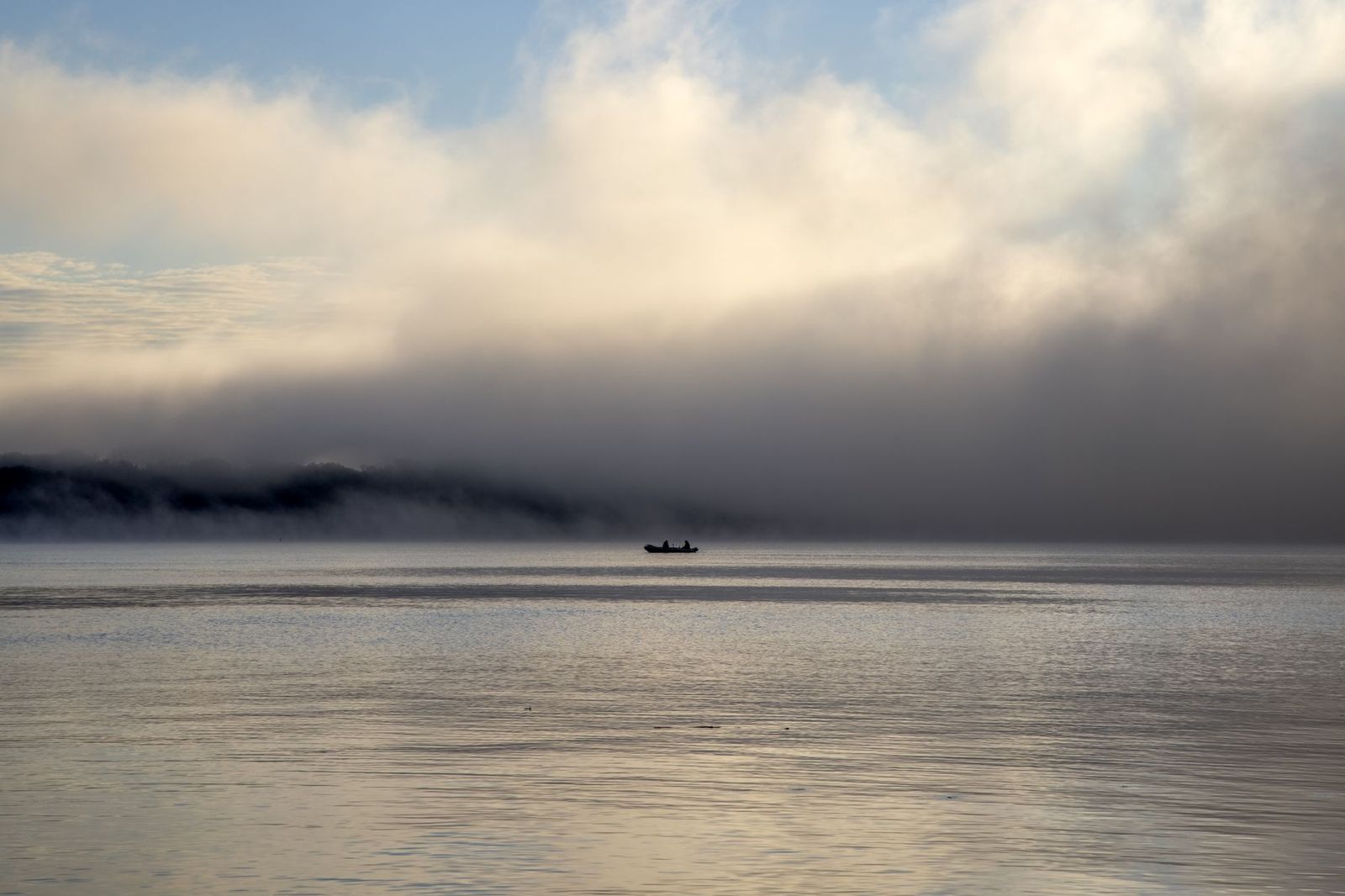 A canoe on a quiet Algonquin lake at sunrise, the picture most visitors drive north for