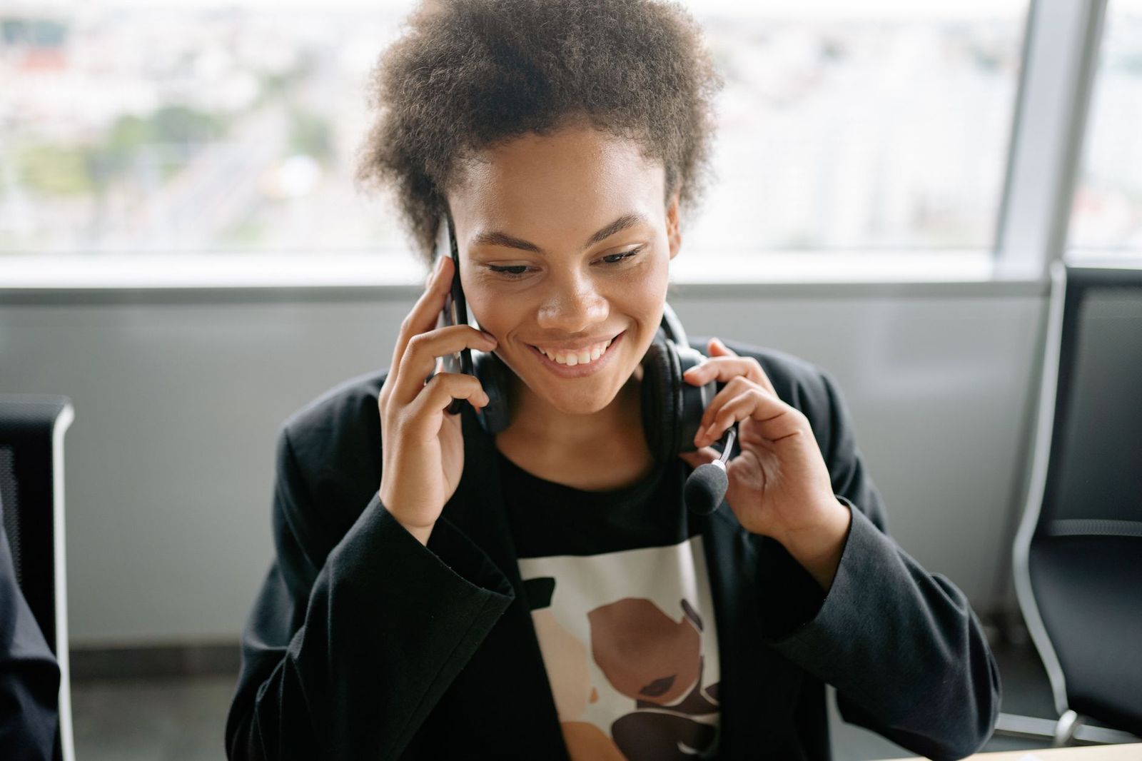 A dispatcher at a desk with a headset and a phone