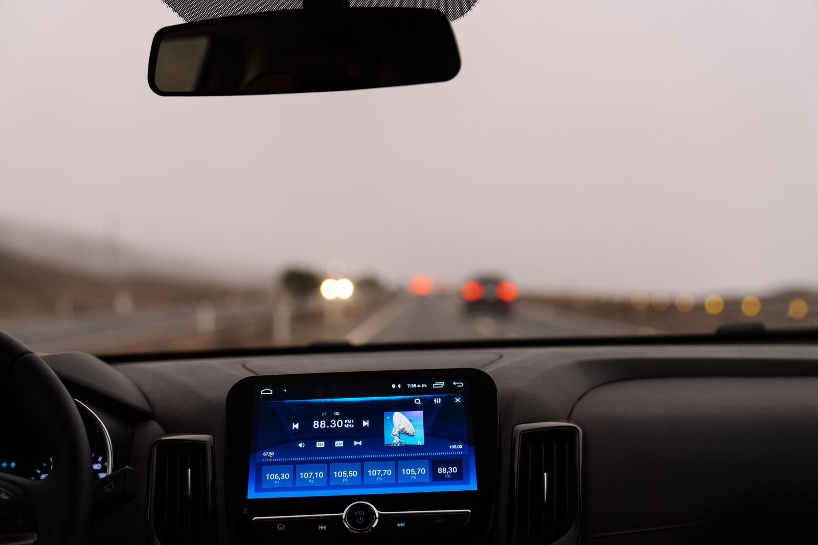 An electric car dashboard screen glowing at night