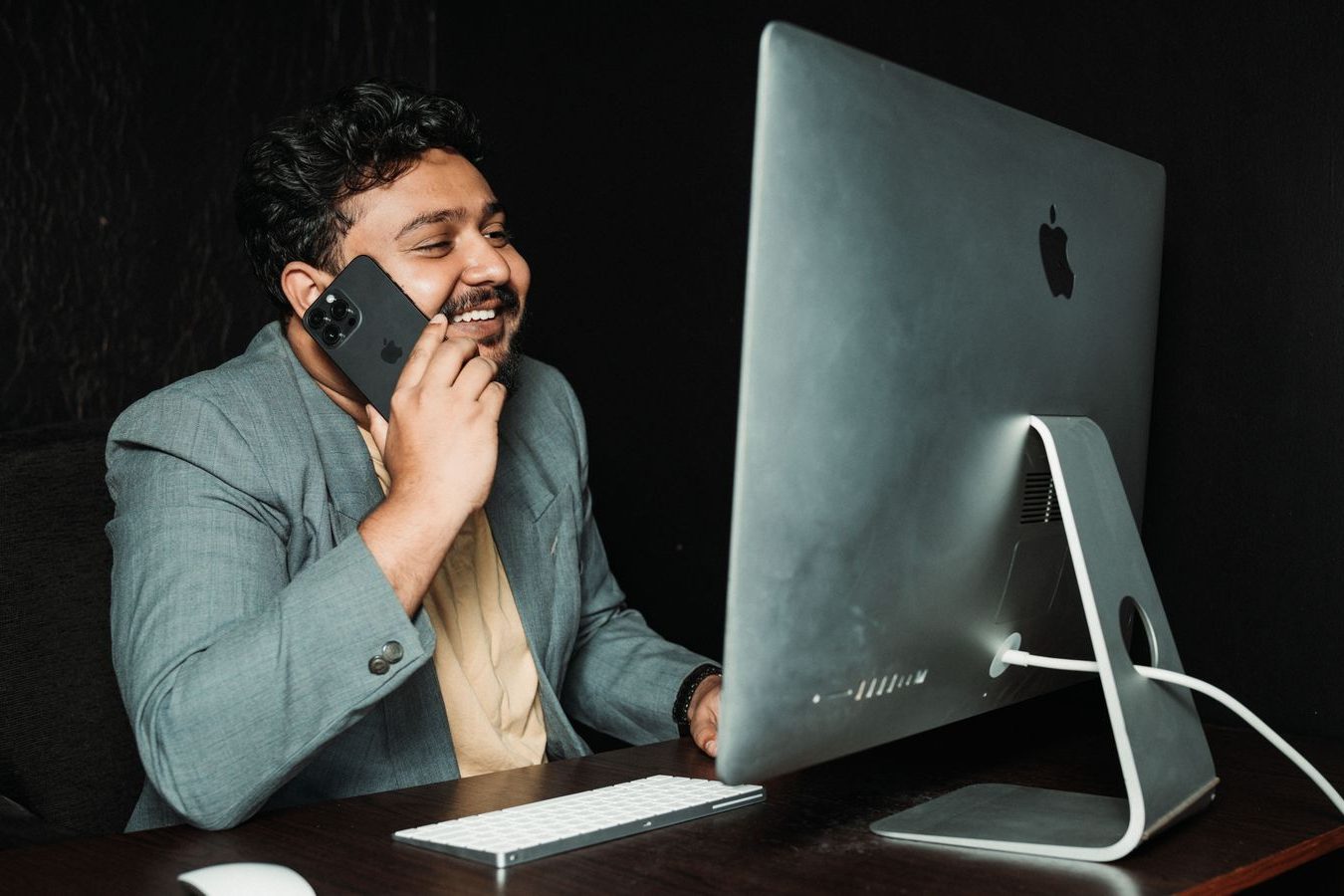 An office manager planning travel on a desk calendar and phone