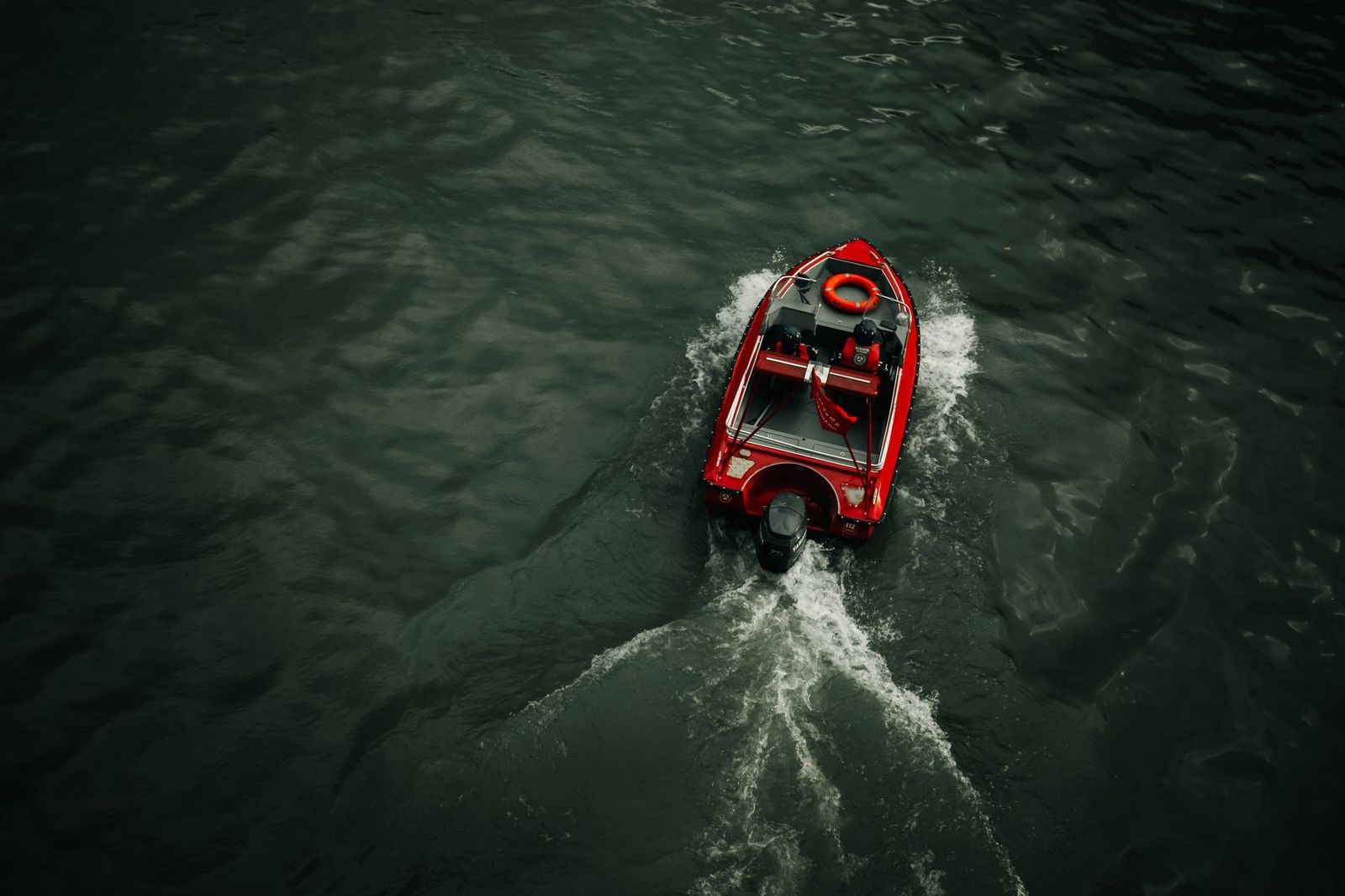 A water taxi crossing open water among granite islands on Georgian Bay