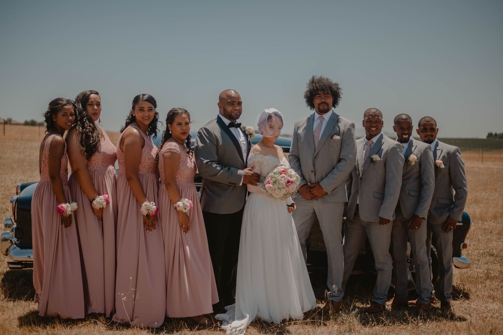 A wedding party stepping out of a limousine