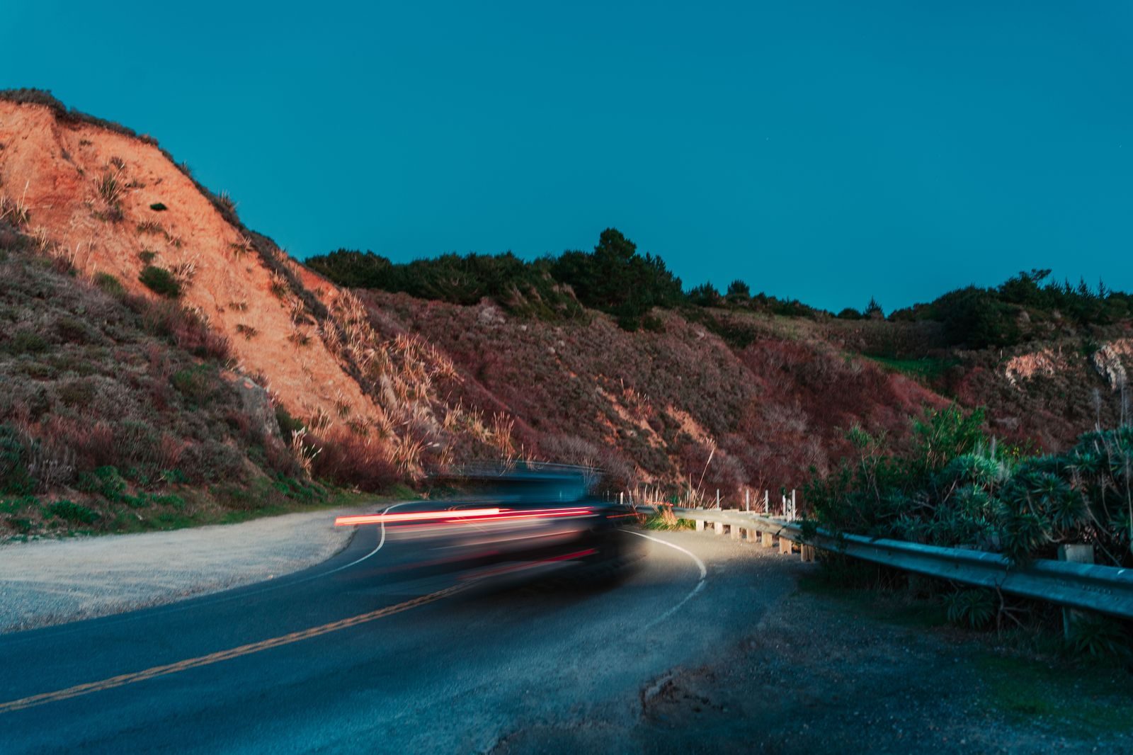 A long highway at sunrise with light traffic