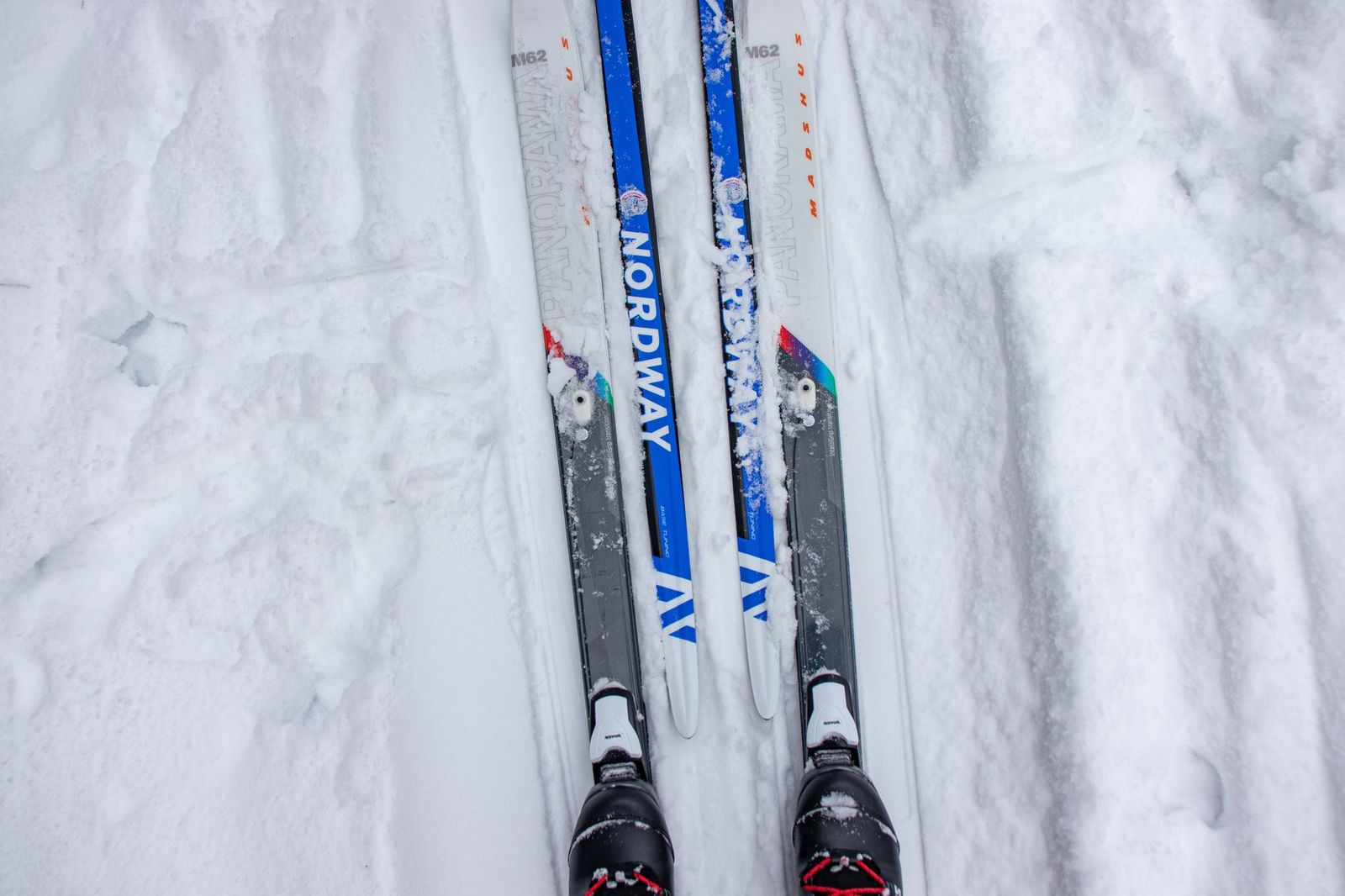Skis, boots and boards packed into the back of a black SUV