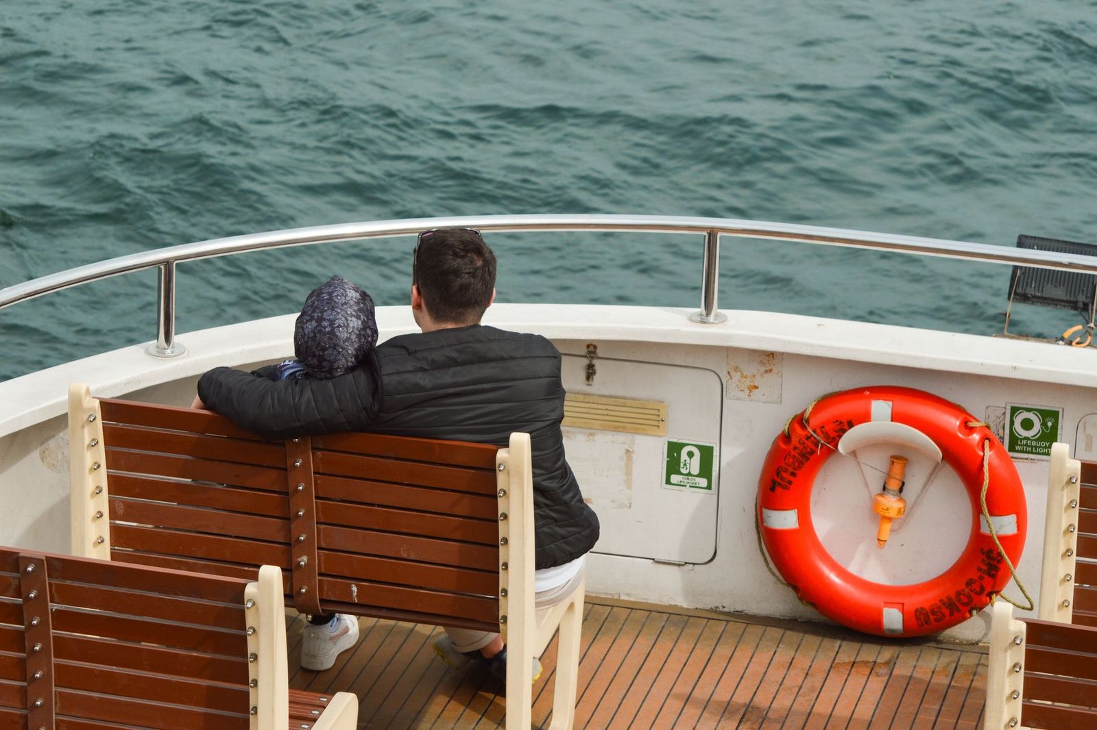 A couple standing at the rail of a lake cruise ship