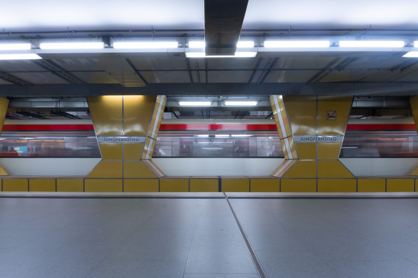 A shuttle train between airport terminals with passengers and luggage on the platform