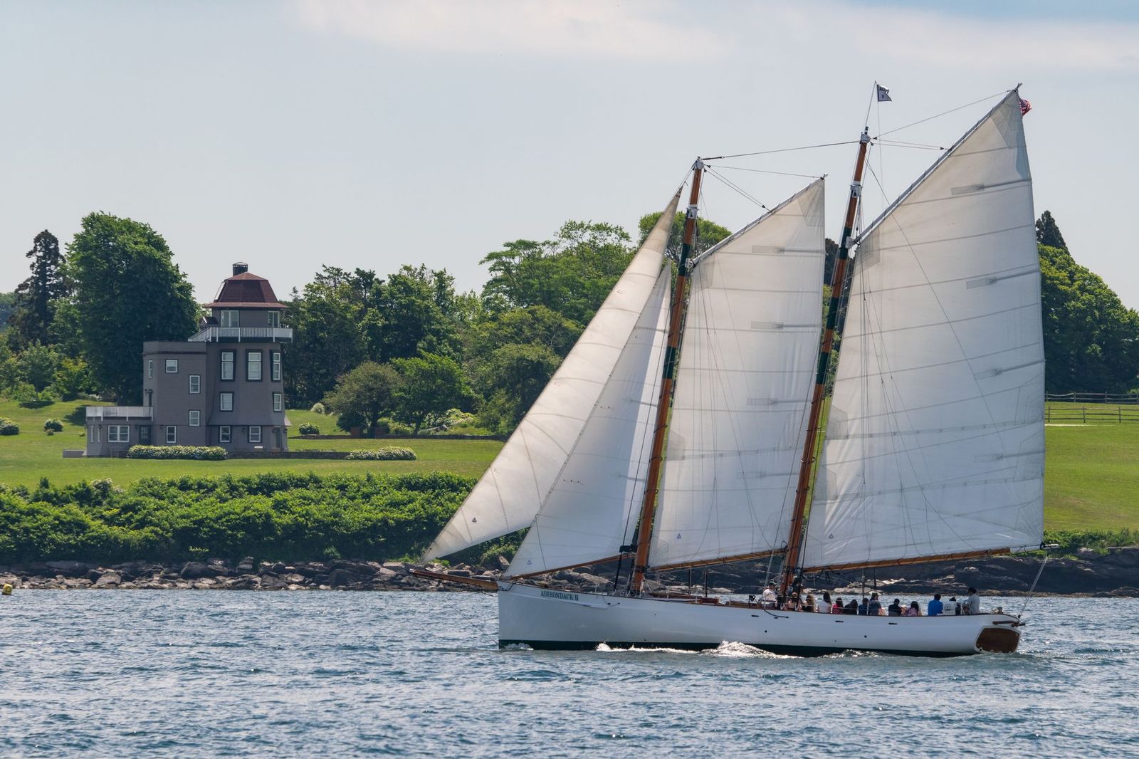 A wooden schooner hull displayed on a small island museum site