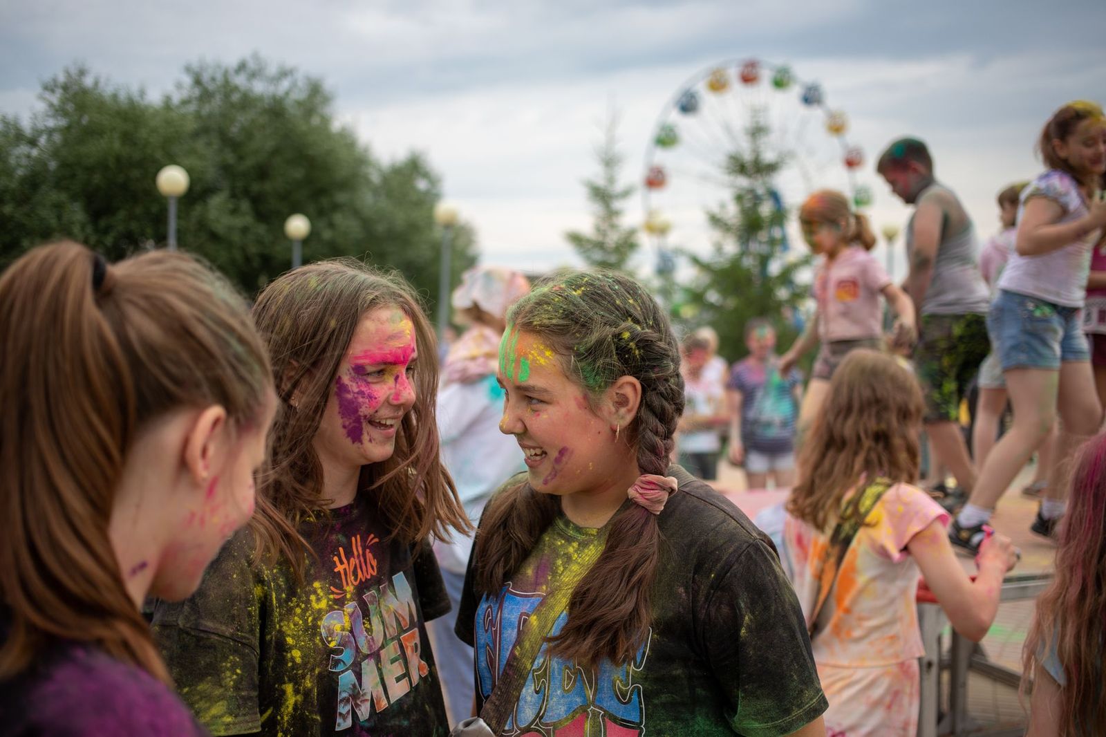 Teenagers laughing together on a theme-park midway
