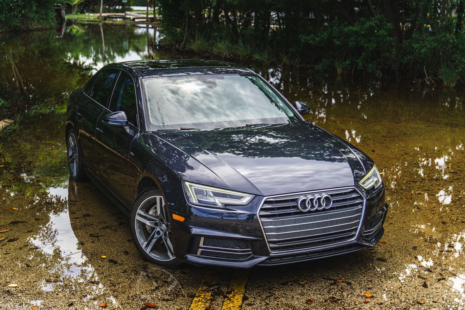 A black business sedan with a chauffeur on a lakeside road near Orillia