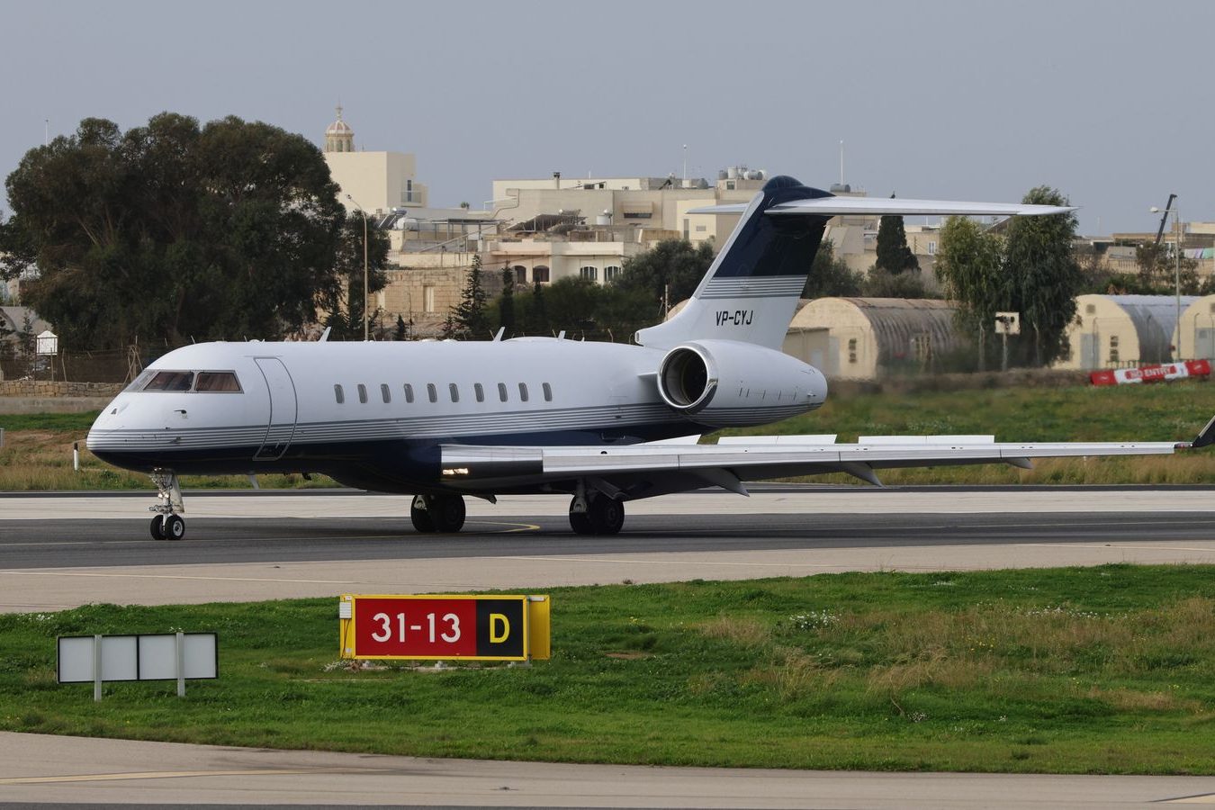 A small airfield apron, the kind of runway where private flights meet a waiting car