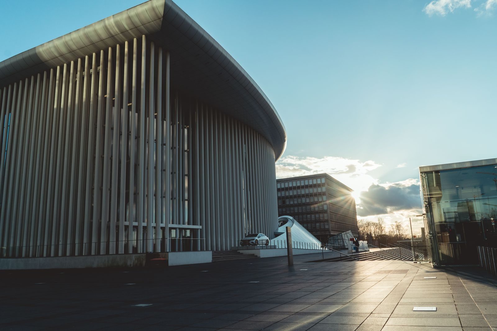A concert hall lit up on a summer evening