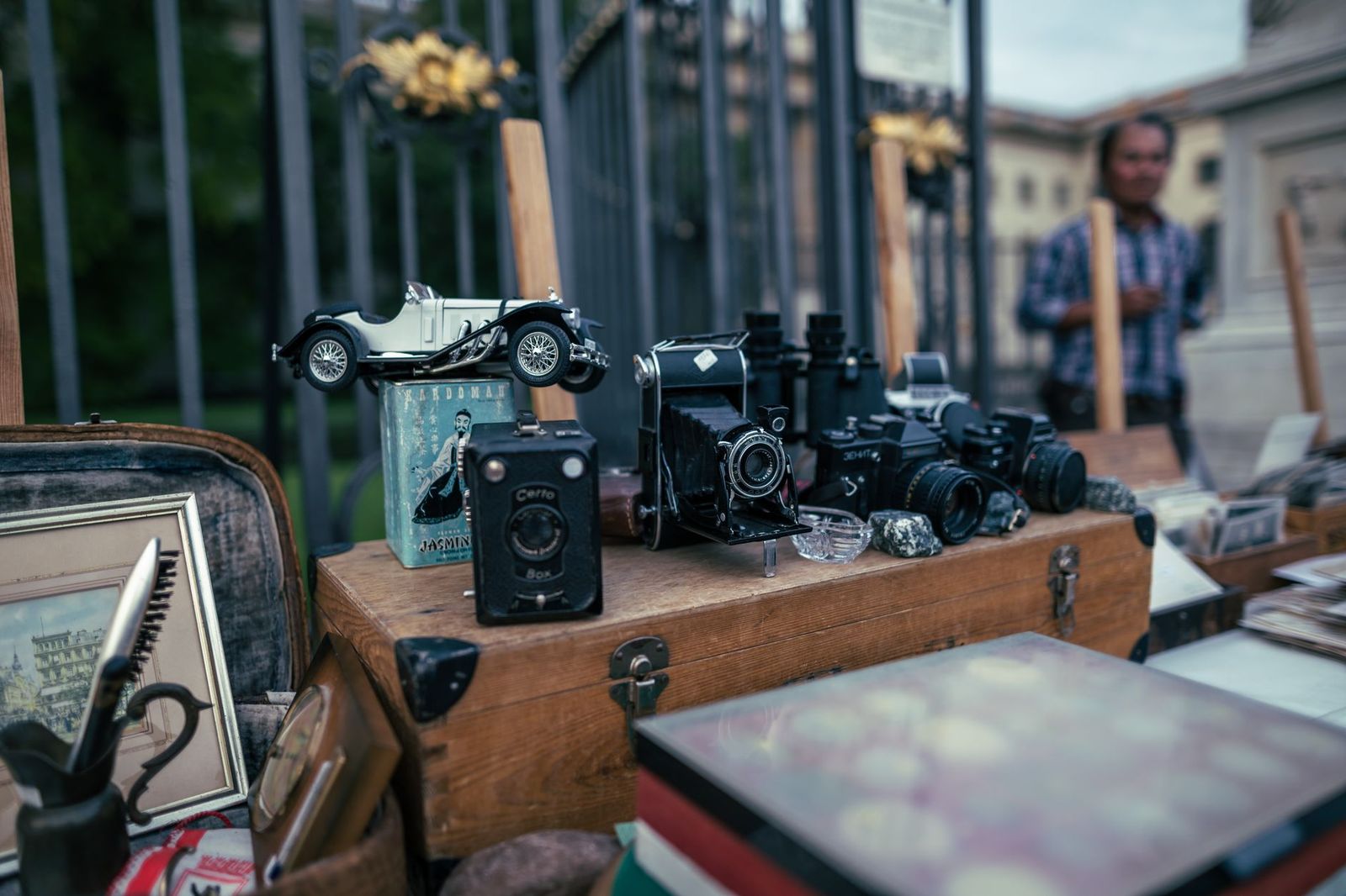 Row of classic cars on display in a field at an automotive flea market