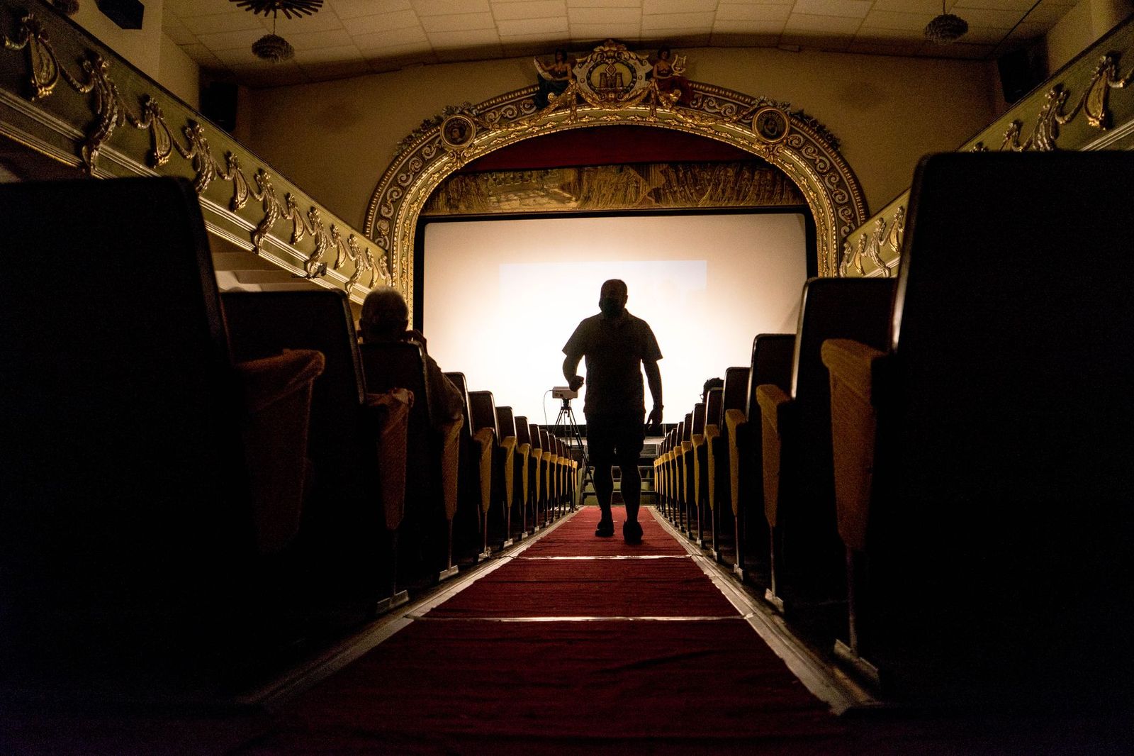 A chauffeur opening the rear door for festival guests on a late-October evening