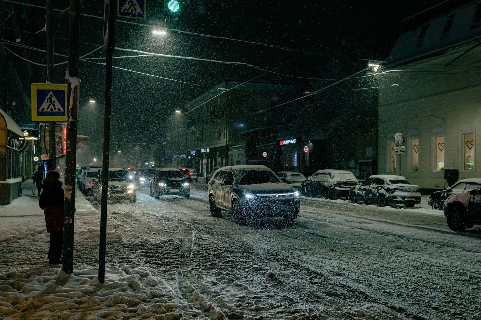 A black SUV on a snowy Barrie street, warm and waiting for Winterfest visitors
