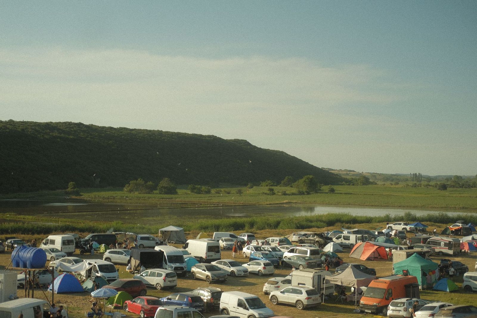 Rows of camping tents in a field at a summer music festival