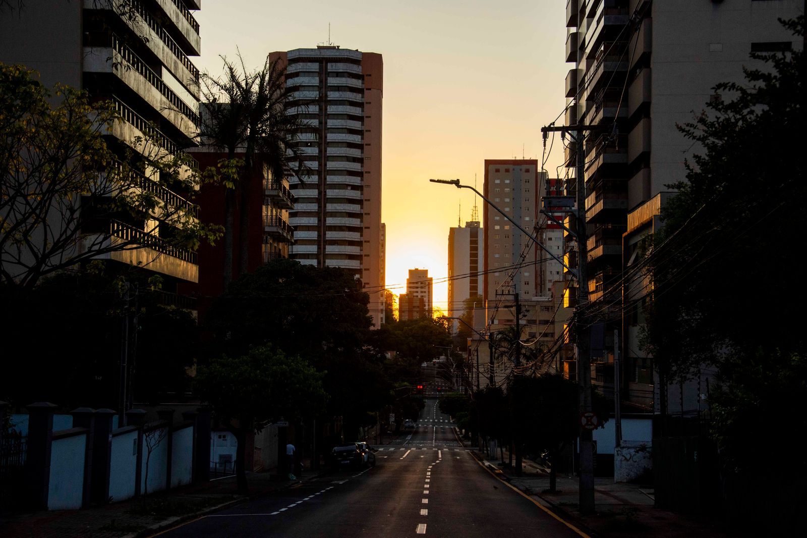 Black sedan on a downtown street in the evening