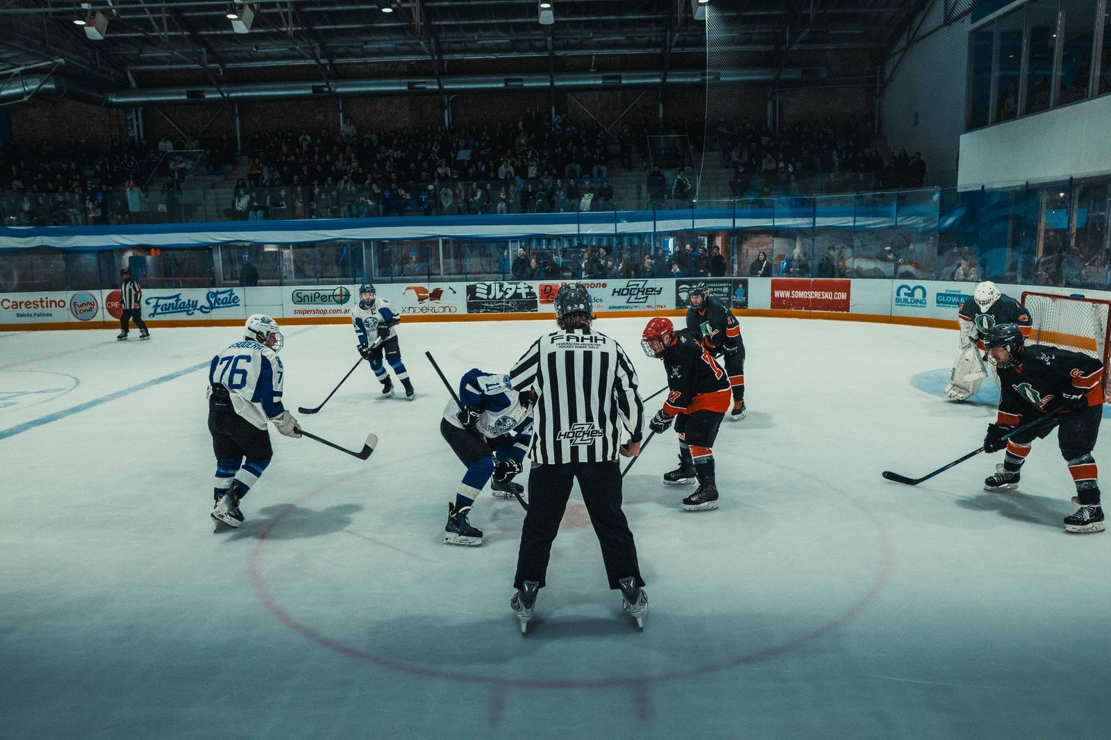 Spectators filling an arena before a hockey game