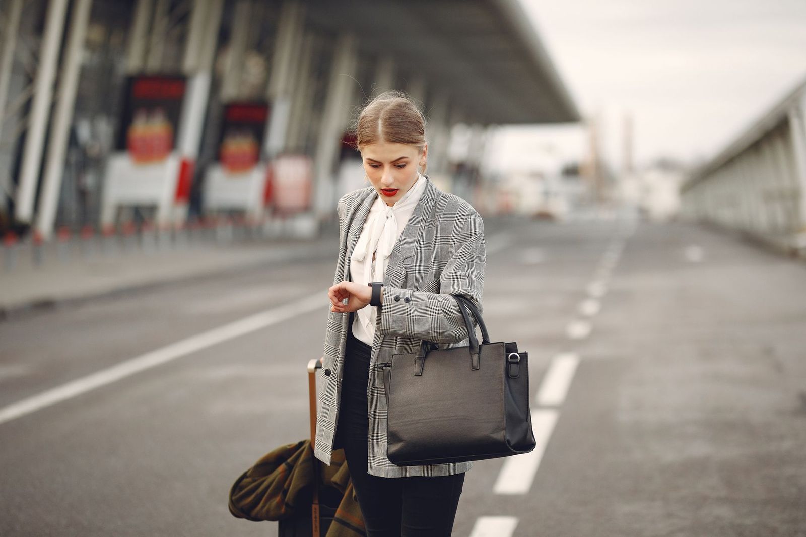 Black sedan waiting at an airport curb
