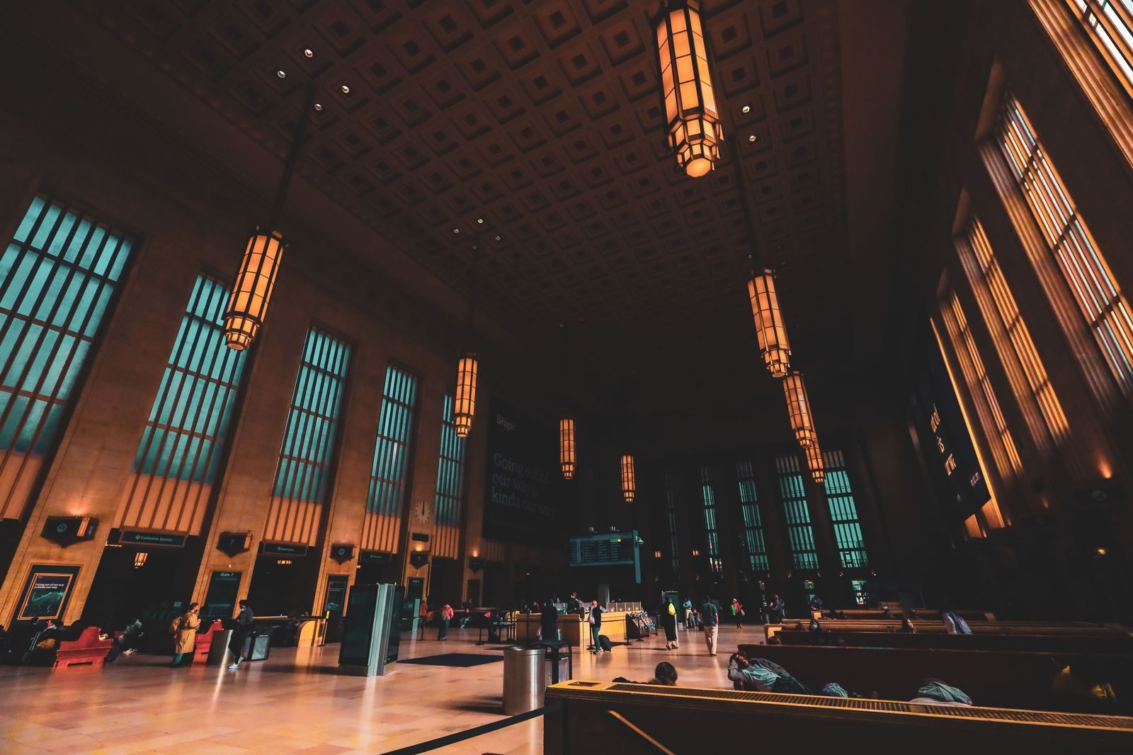 Travellers in the great hall of a city train station
