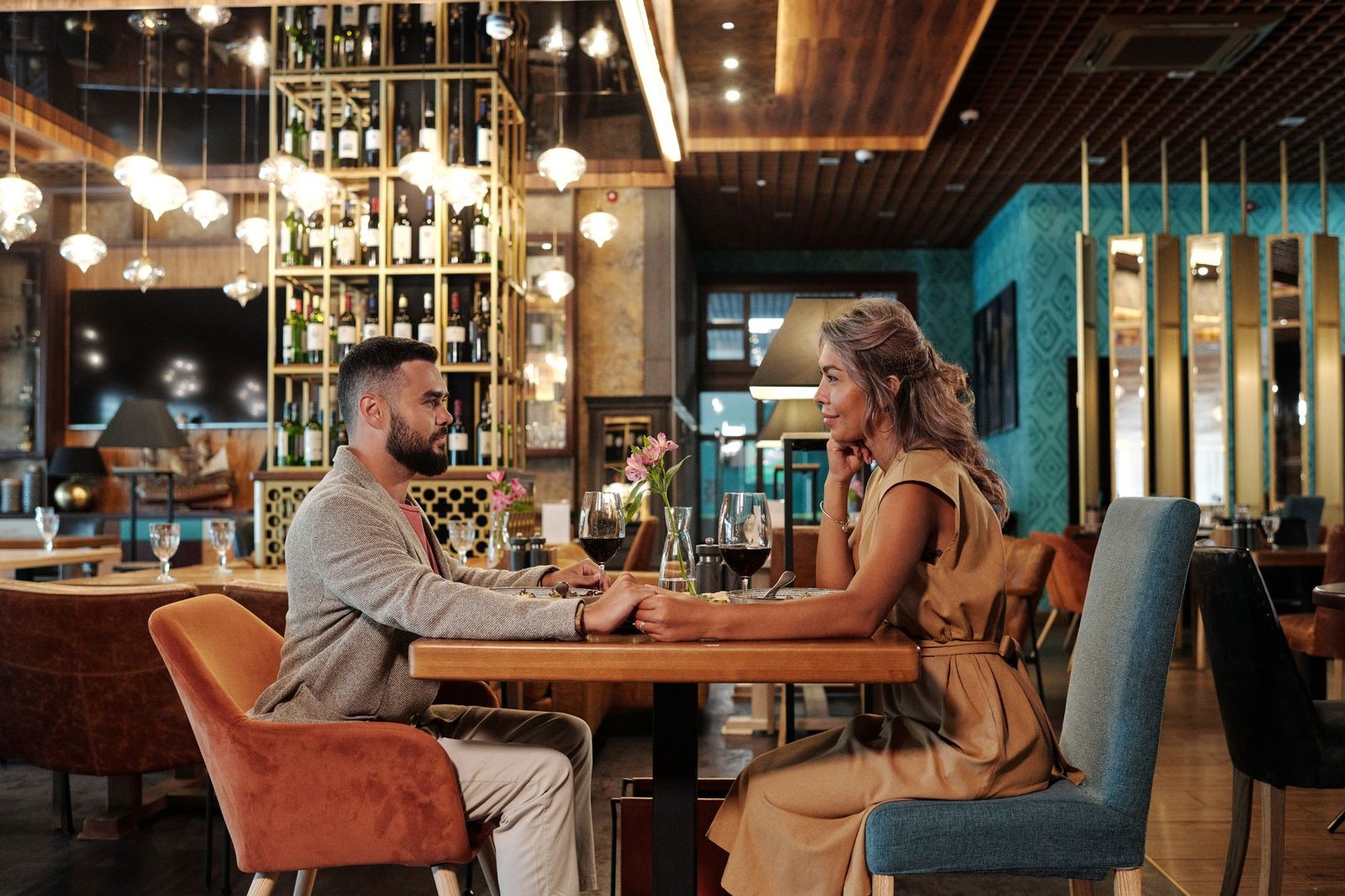 A couple at a candlelit restaurant table on an anniversary evening