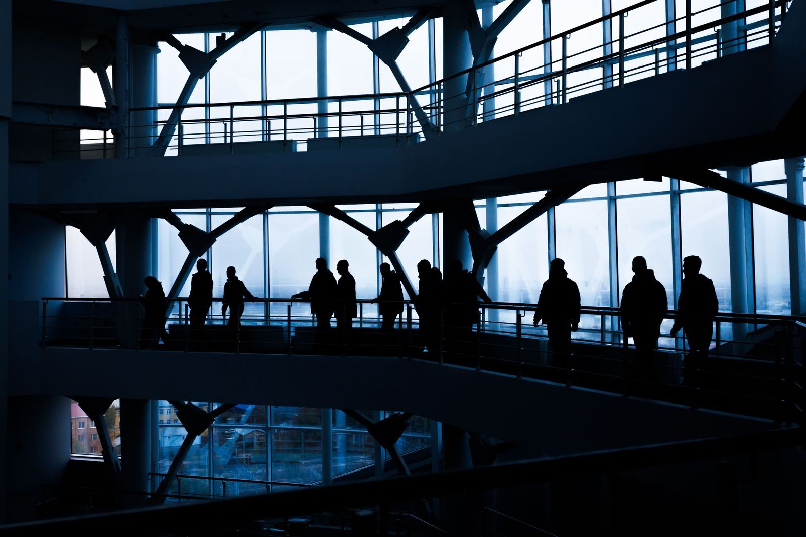 Business people walking along a glass office building