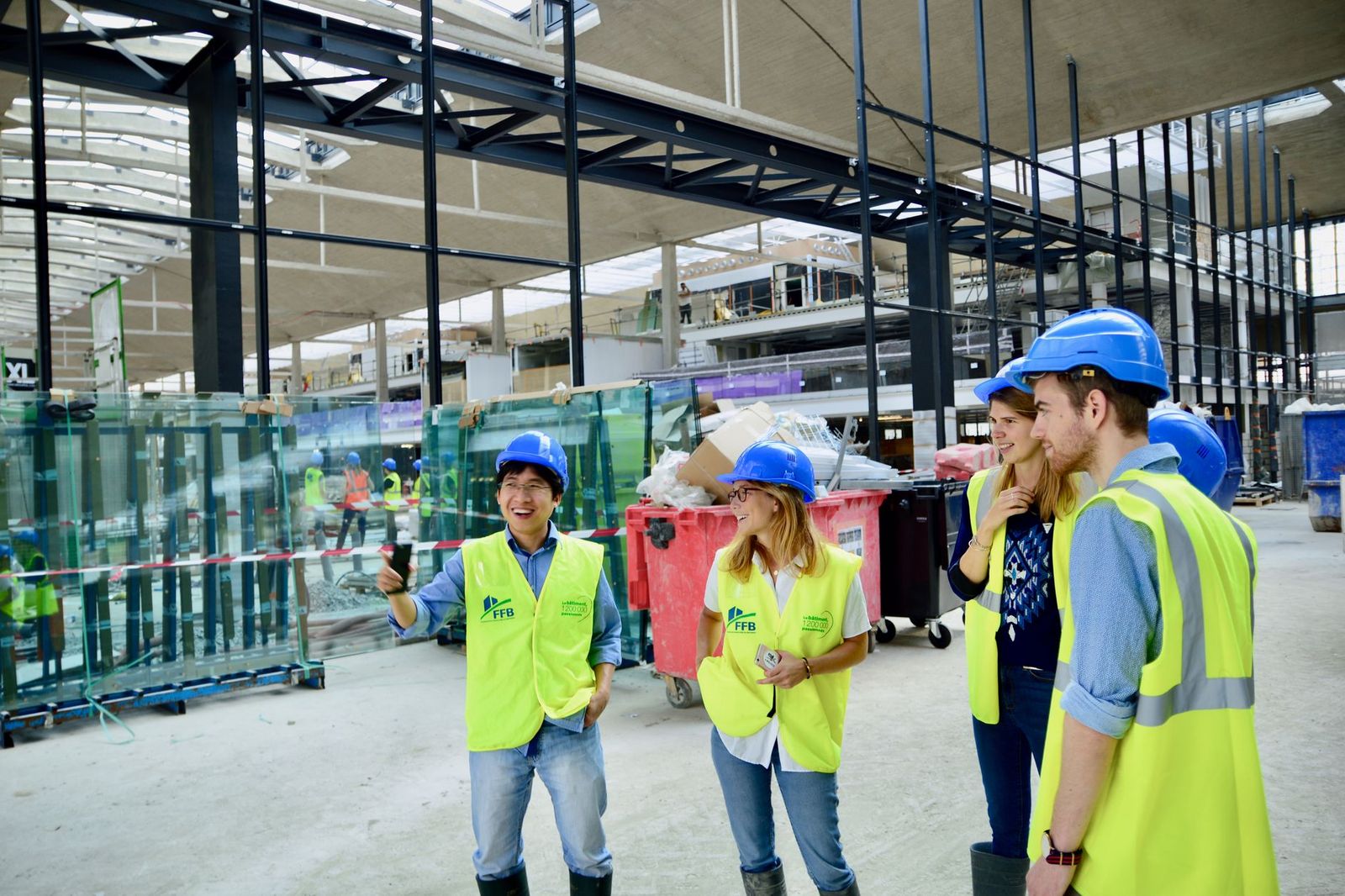Visitors in hard hats on a construction site tour