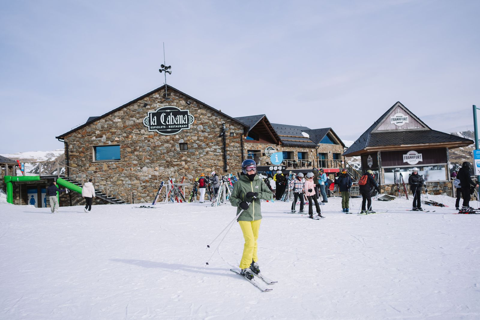 Skier carrying skis toward the ski lodge at a Georgian Bay resort