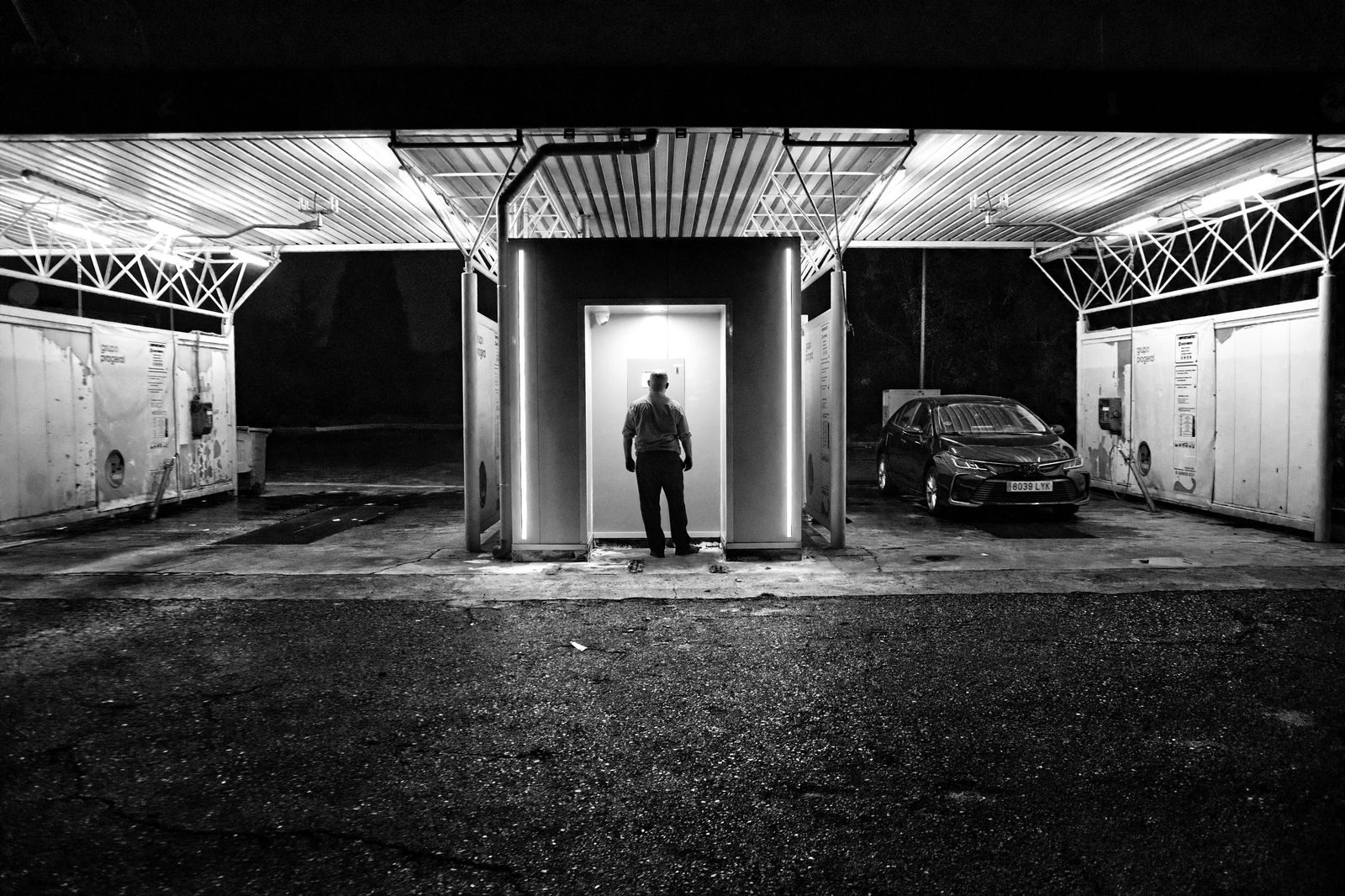 A black car waiting on a downtown Toronto street in the evening