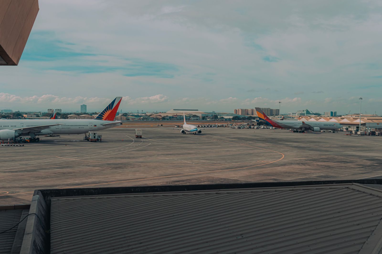 Travellers with luggage in an airport arrivals hall: a private car means the car is already waiting at the curb when you come out