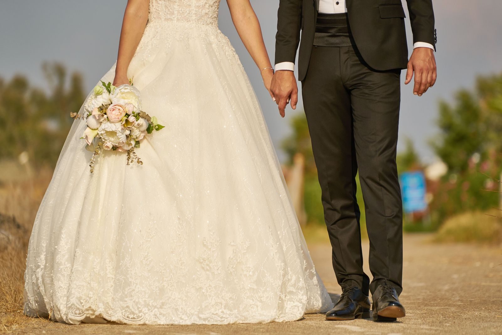 A wedding couple beside a black limousine, one of the occasions where a partner stretch is booked through BarrieLimo.net