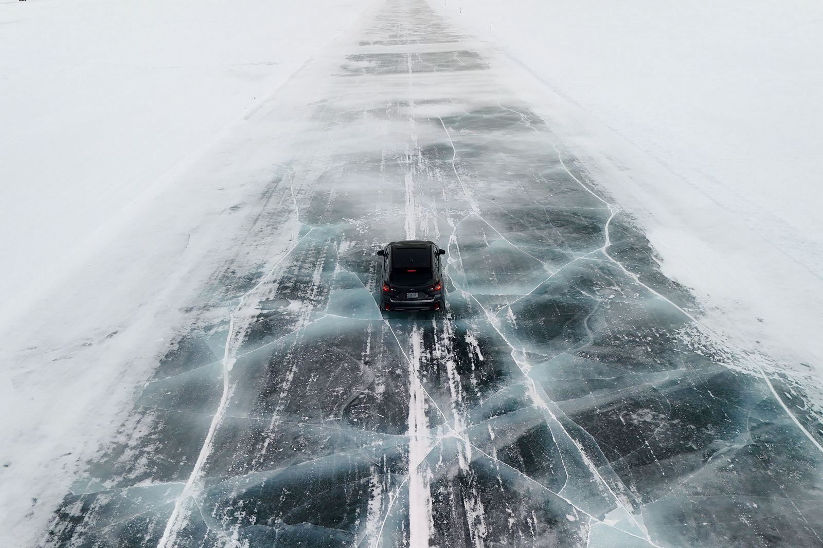 A black SUV driving a snowy Highway 400 towards the Georgian Bay ski hills